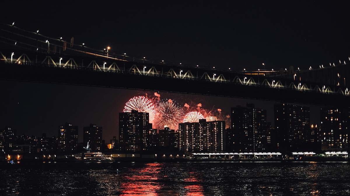 brooklyn bridge fireworks on city building during nighttime new york